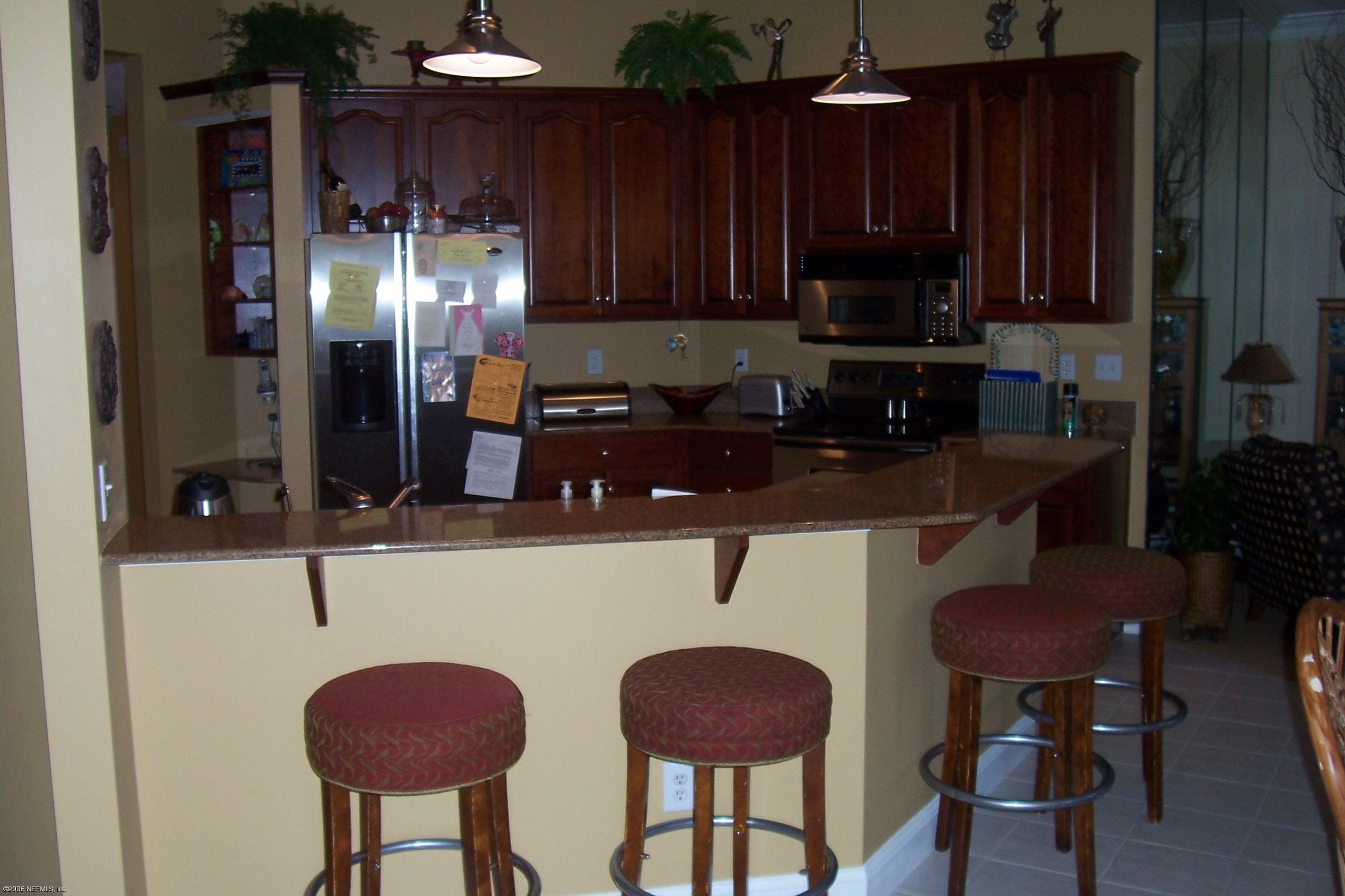 200 Clatter Bridge Road Ponte Vedra Beach, FL 32081 - Photo 6 of 12 a kitchen with stainless steel appliances a sink cabinets and wooden floor