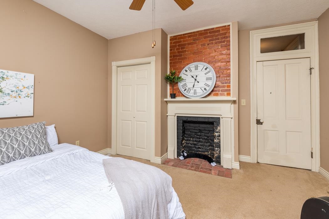 1594 Tinkling Spring Road Staunton, VA 24401 - Photo 44 of 69 a bedroom with a fireplace and a bed