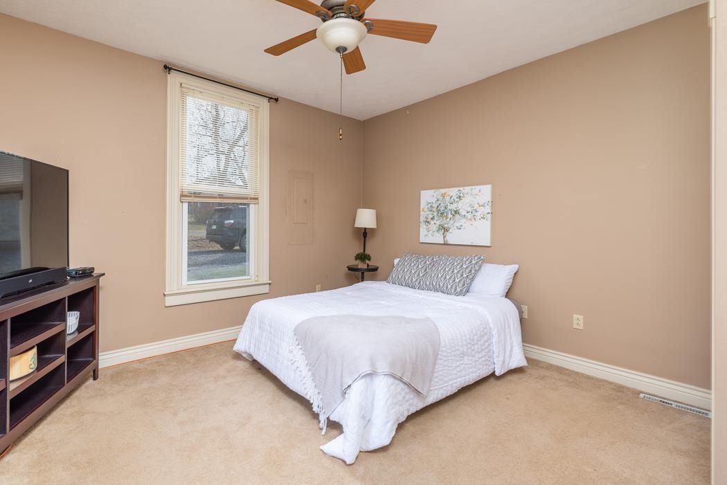 1594 Tinkling Spring Road Staunton, VA 24401 - Photo 45 of 69 a bed sitting in a bedroom next to a window