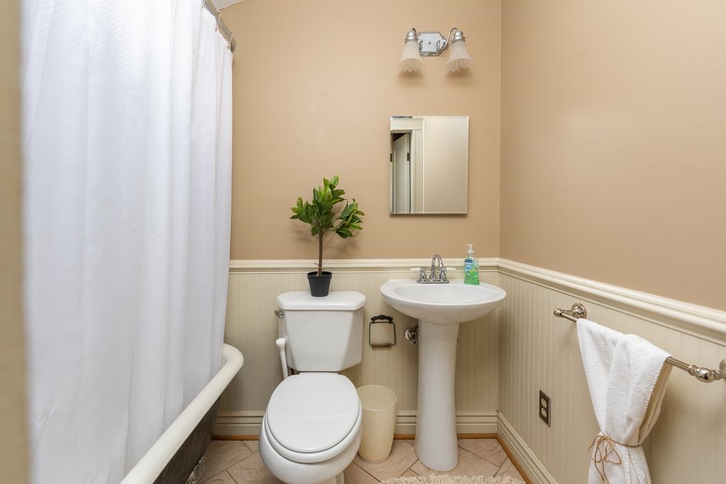 1594 Tinkling Spring Road Staunton, VA 24401 - Photo 46 of 69 a bathroom with a toilet sink and mirror