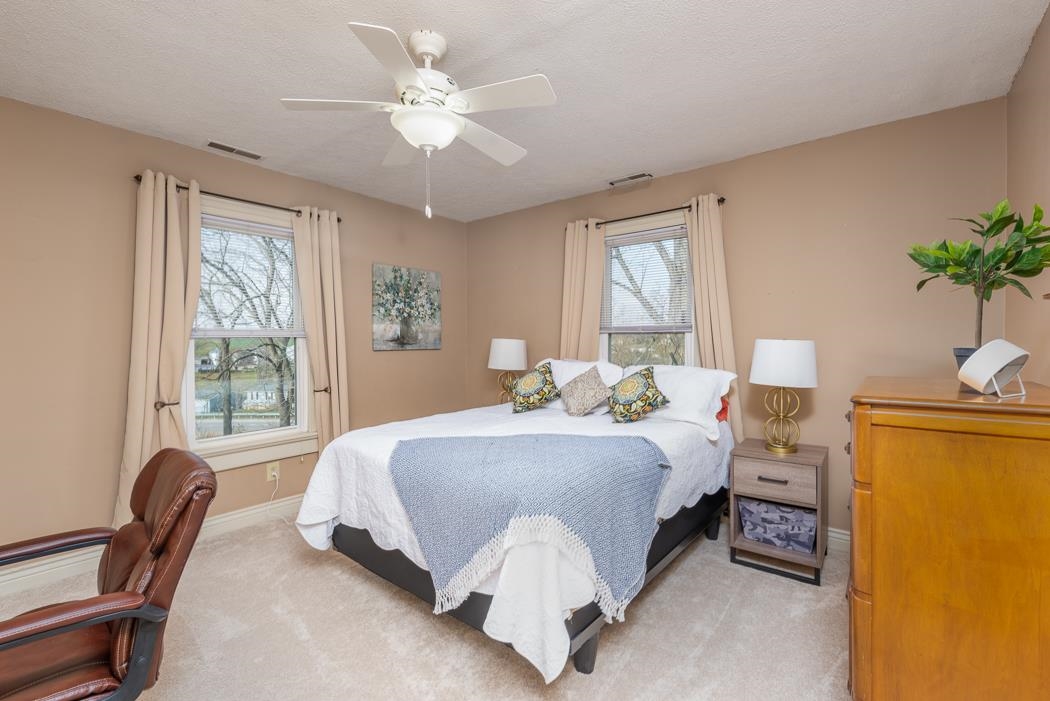 1594 Tinkling Spring Road Staunton, VA 24401 - Photo 49 of 69 a spacious bedroom with a bed and a chandelier