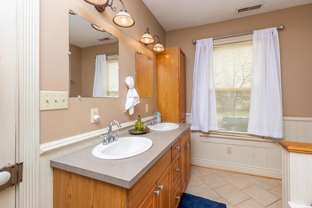 1594 Tinkling Spring Road Staunton, VA 24401 - Photo 55 of 69 a bathroom with a sink vanity tub and a mirror