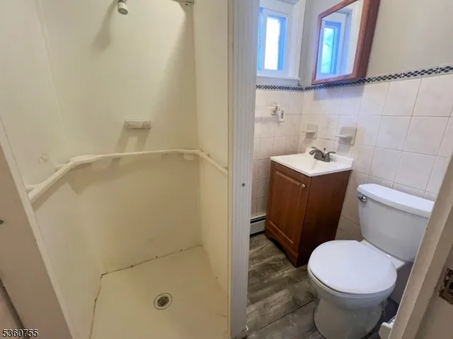 a white toilet sitting next to a bathroom sink
