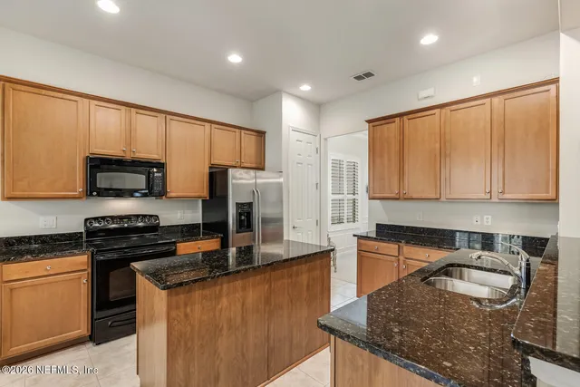 a living room with couches a dining table and chairs with wooden floor