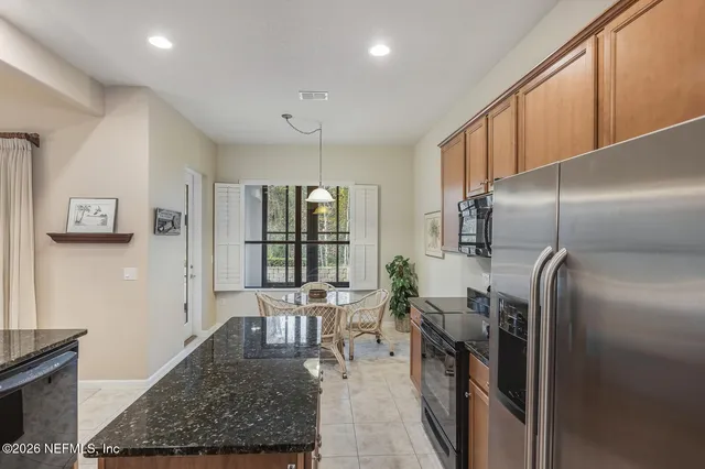 a kitchen with granite countertop a sink and cabinets
