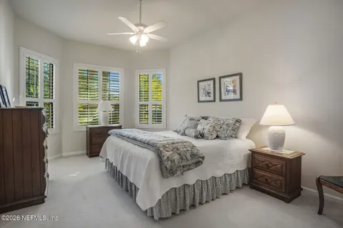 a spacious bathroom with a tub sink and mirror