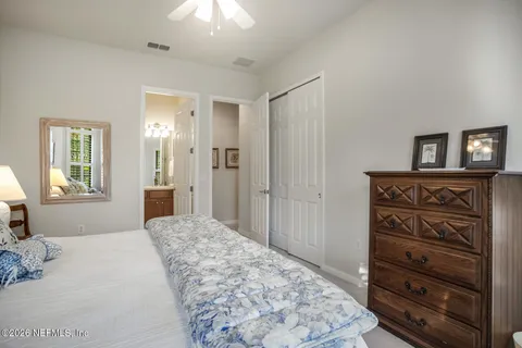 a spacious en suite bathroom with double sink and a mirror