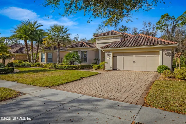 a living room with furniture and a mirror