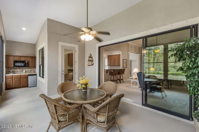 a dining room with furniture a chandelier and wooden floor