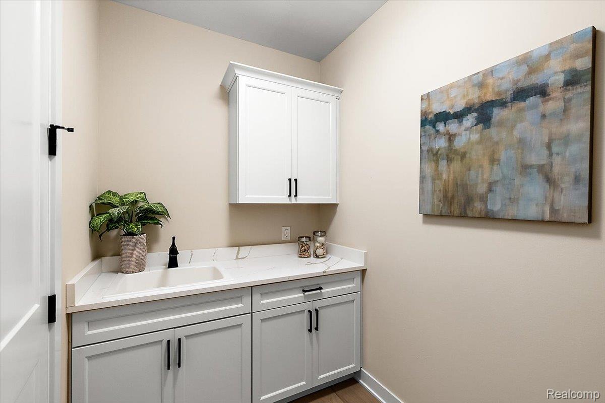 2032 Breckenridge Court, Unit 9 Rochester, MI 48309 - Photo 30 of 39 Laundry room featuring a sink and dark wood-style flooring