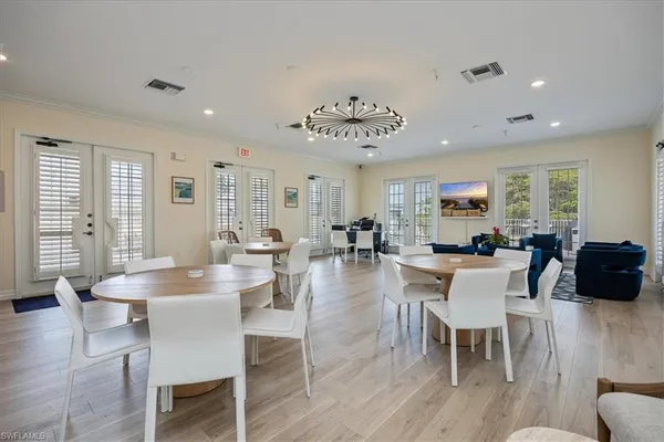 a living room with furniture kitchen view and a large window