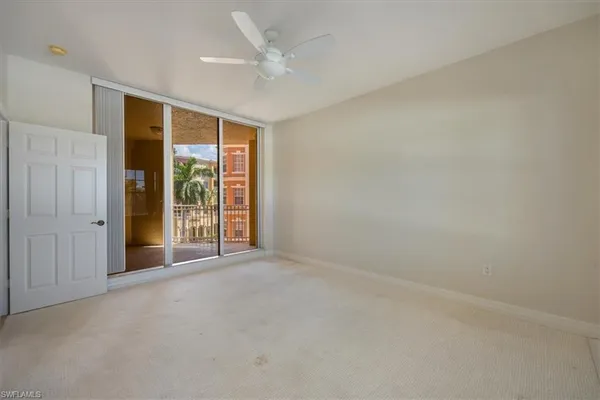 an empty room with windows and closet