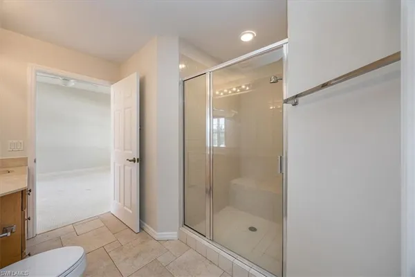 a bathroom with a shower and a toilet