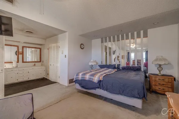 a bedroom with a bed and a cabinets