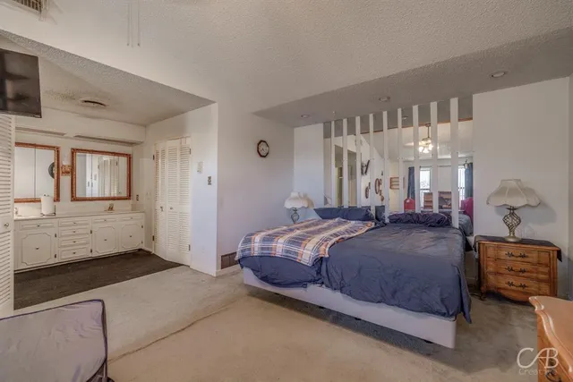 a bedroom with a bed and a cabinets