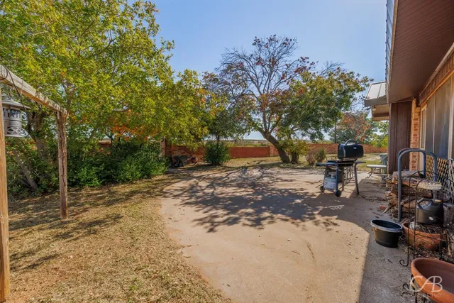 a view of a backyard with sitting area