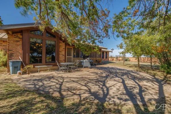 a view of a backyard with sitting area