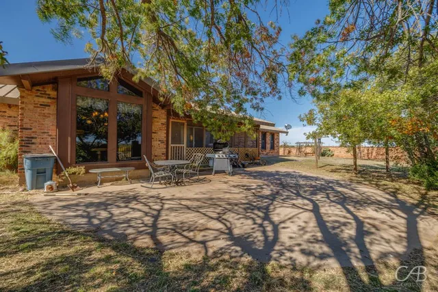 a view of a backyard with sitting area