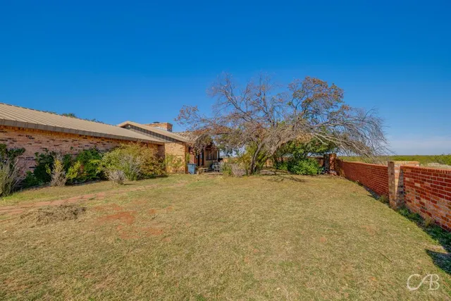 a swimming pool with an outdoor space and seating area