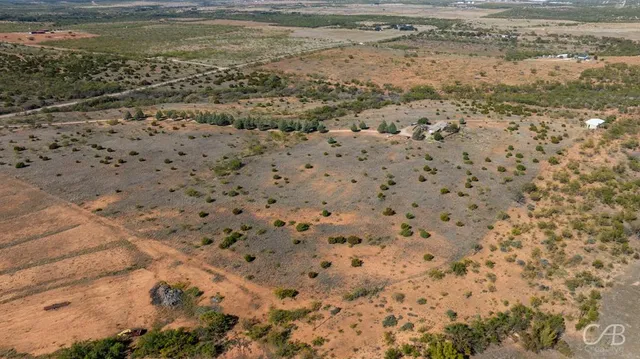 an aerial view of a houses with a yard
