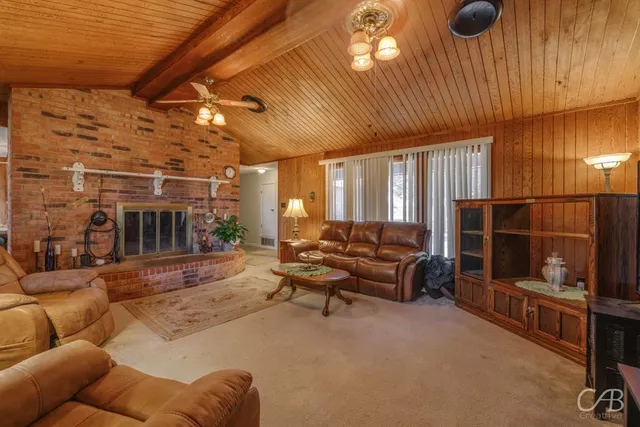 a living room with furniture a flat screen tv and a table