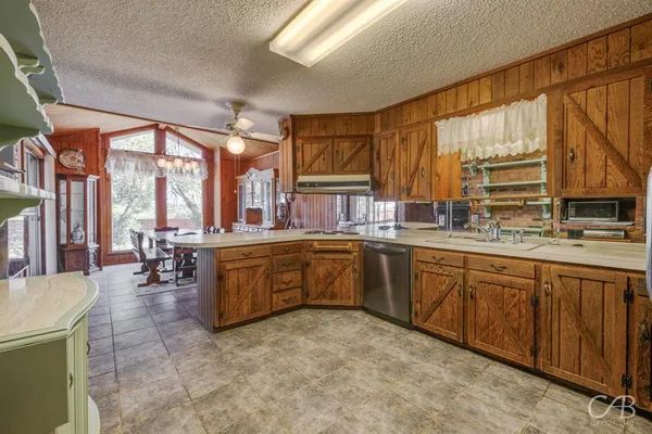 a kitchen with sink cabinets and dining table