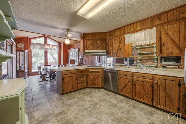 a kitchen with sink cabinets and dining table