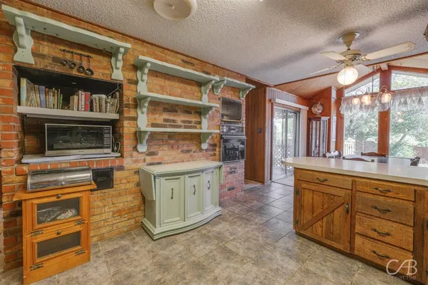 a kitchen with stainless steel appliances granite countertop a stove and cabinets