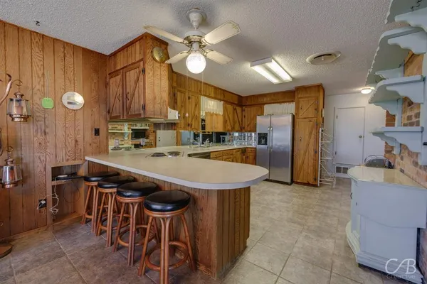 a kitchen with stainless steel appliances a sink stove and cabinets