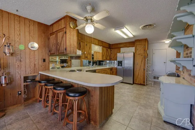 a kitchen with stainless steel appliances a sink stove and cabinets