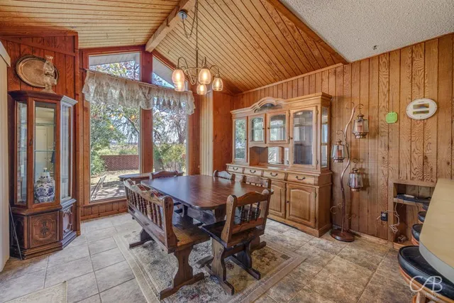 a dining room with furniture and window