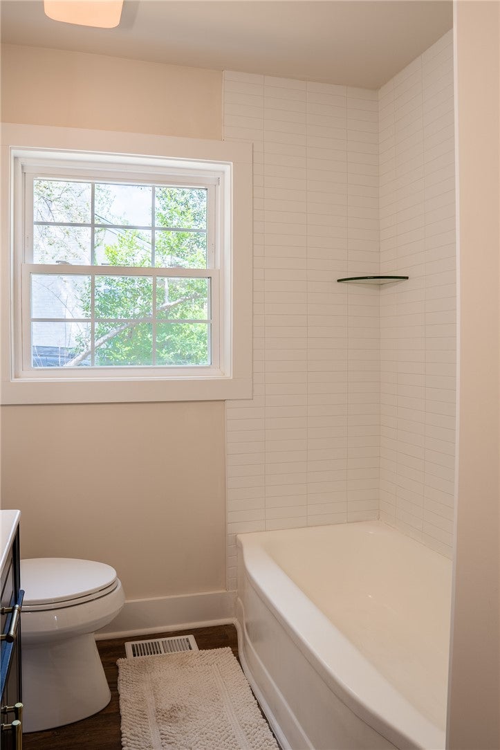 1312 Rocky Brook Road Opelika, AL 36801 - Photo 22 of 45 This bright bathroom features a classic bathtub with tiled walls and a large window.
