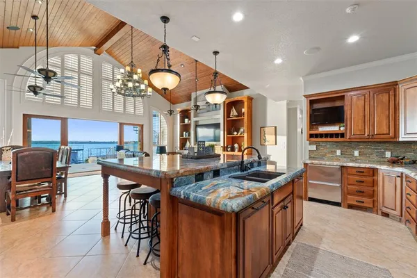 a kitchen with stainless steel appliances granite countertop a stove and a sink