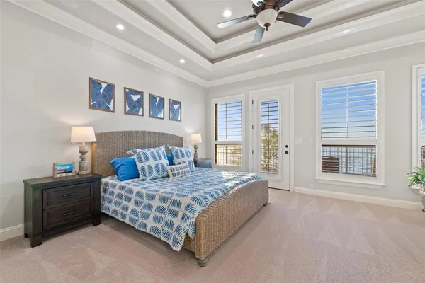 a bedroom with a large bed and a chandelier