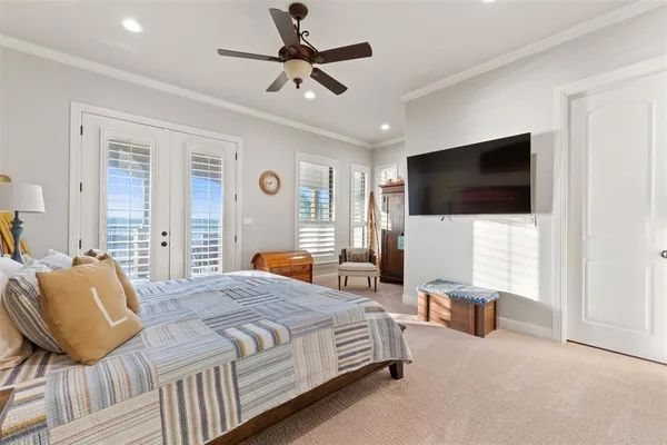 a bedroom with a bed a flat screen tv and a couch