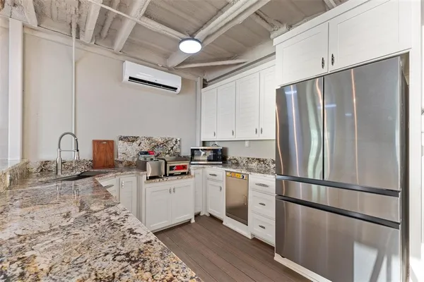 a kitchen with stainless steel appliances granite countertop a refrigerator sink and stove
