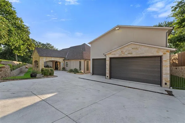 a view of a house with a yard and garage