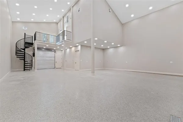 an empty room with kitchen and stainless steel appliances
