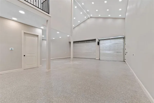 an empty room with cabinet and mirrors