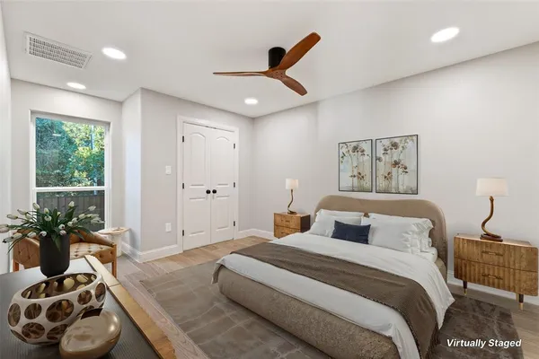 a bedroom with a large bed and a window
