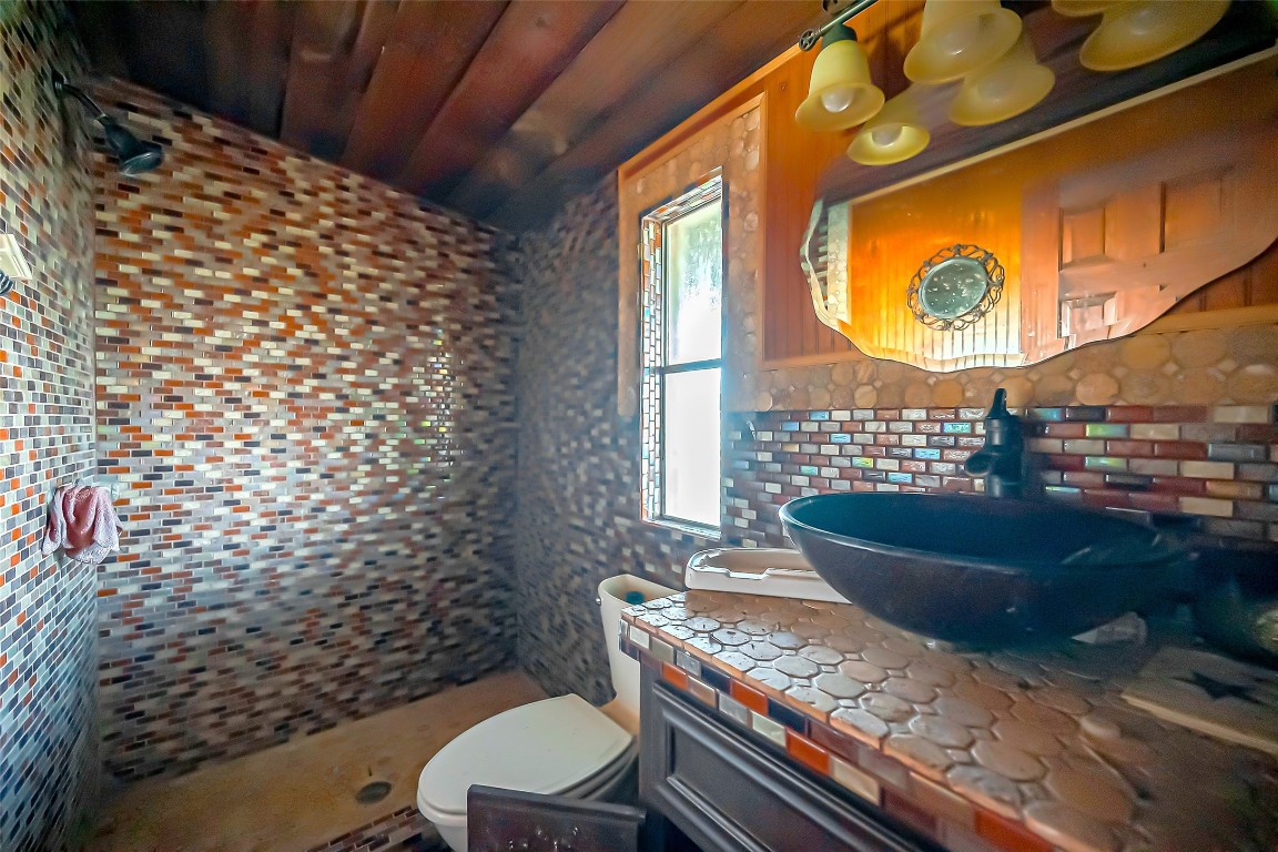 2830 County Road 290 Angleton, TX 77515 - Photo 5 of 11 a bathroom with a toilet and a shower curtain