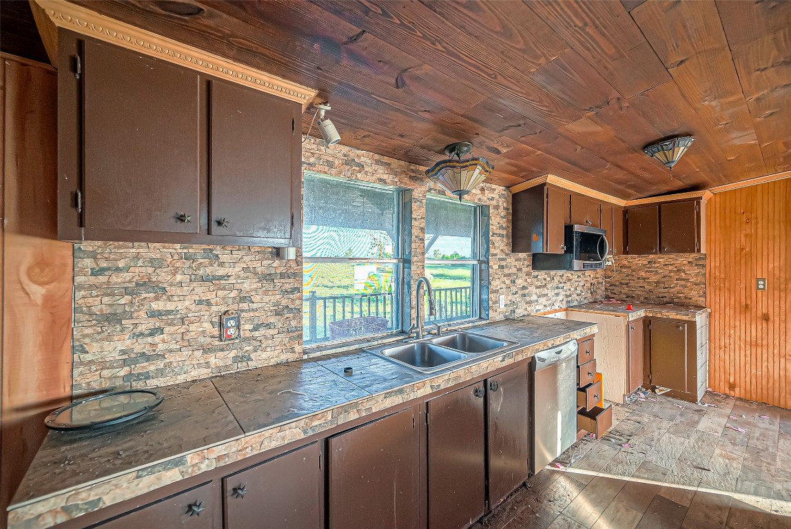 2830 County Road 290 Angleton, TX 77515 - Photo 10 of 11 a kitchen with stainless steel appliances granite countertop a sink stove and cabinets