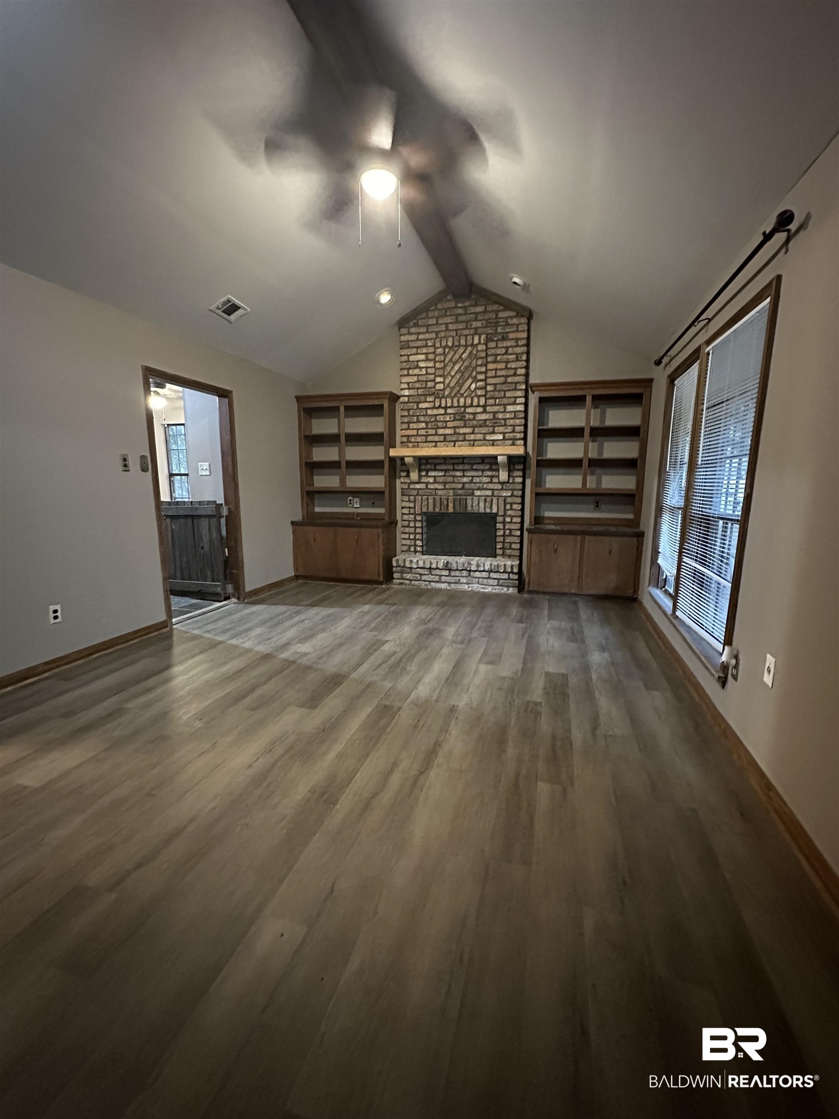 4131 Springdale Road Mobile, AL 36609 - Photo 22 of 28 Unfurnished living room with a brick fireplace, dark wood finished floors, a ceiling fan, and built in features