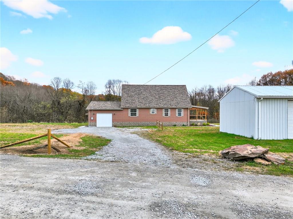 524 Sawmill Road Dawson, PA 15428 - Photo 3 of 50 a view of a big house with a big yard and large trees