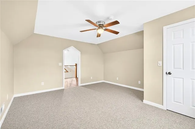 an empty room with closet and fan