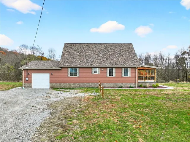 a front view of a house with garden