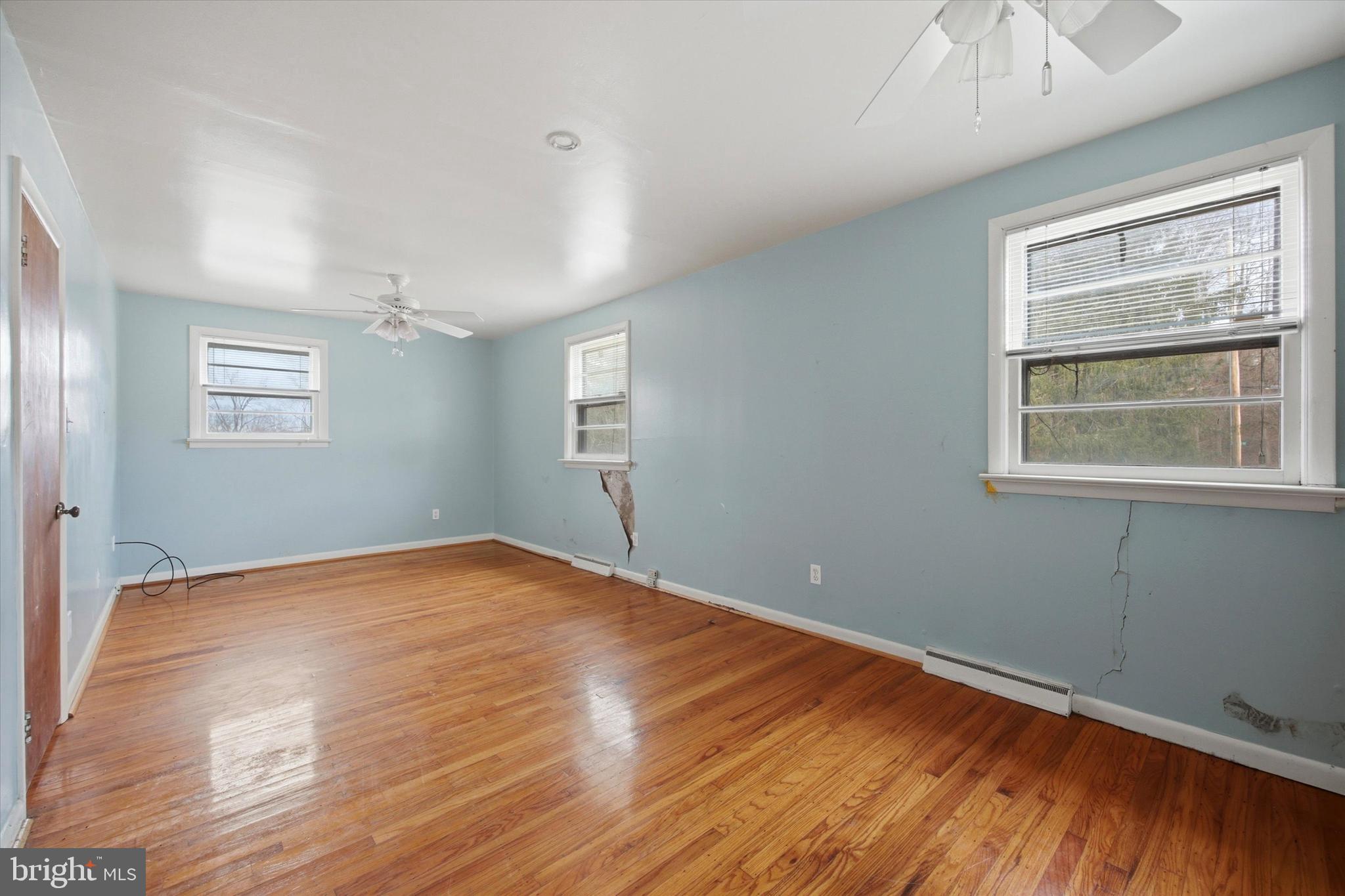 129 Locksley Road Glen Mills, PA 19342 - Photo 12 of 36 a view of empty room with wooden floor and fan