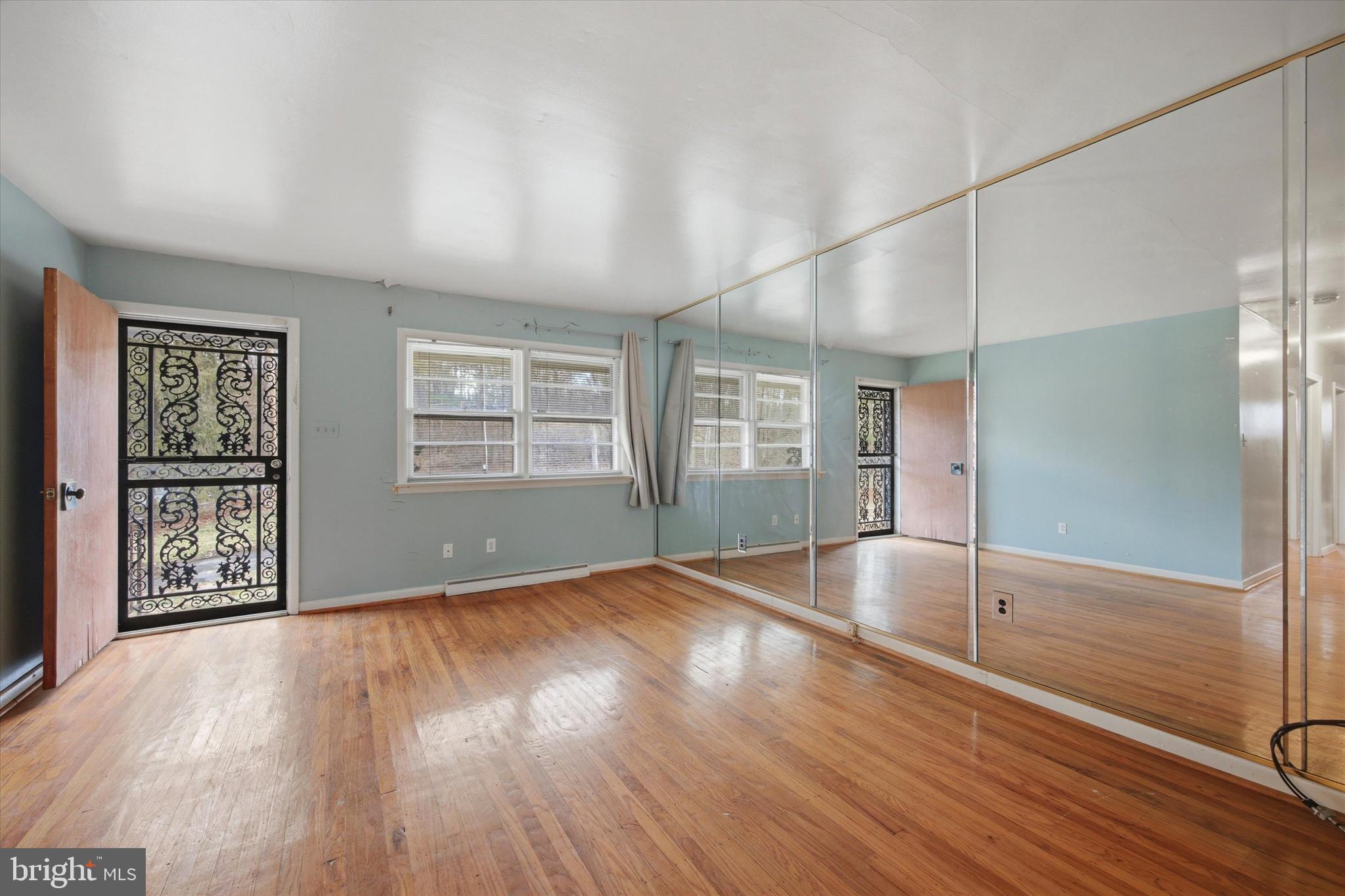 129 Locksley Road Glen Mills, PA 19342 - Photo 7 of 36 a view of an empty room with window and wooden floor