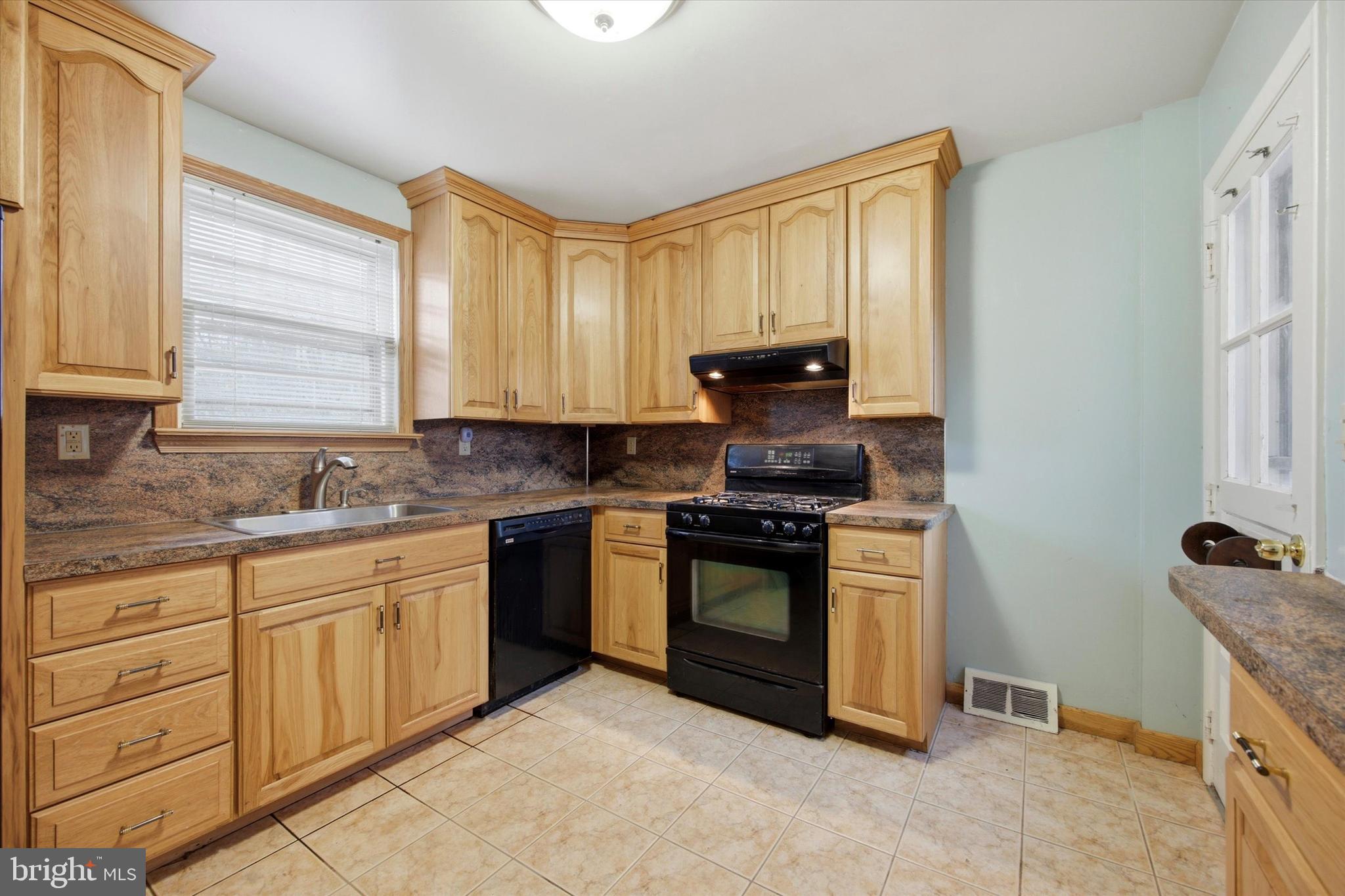 129 Locksley Road Glen Mills, PA 19342 - Photo 9 of 36 a kitchen with granite countertop a sink stove and cabinets