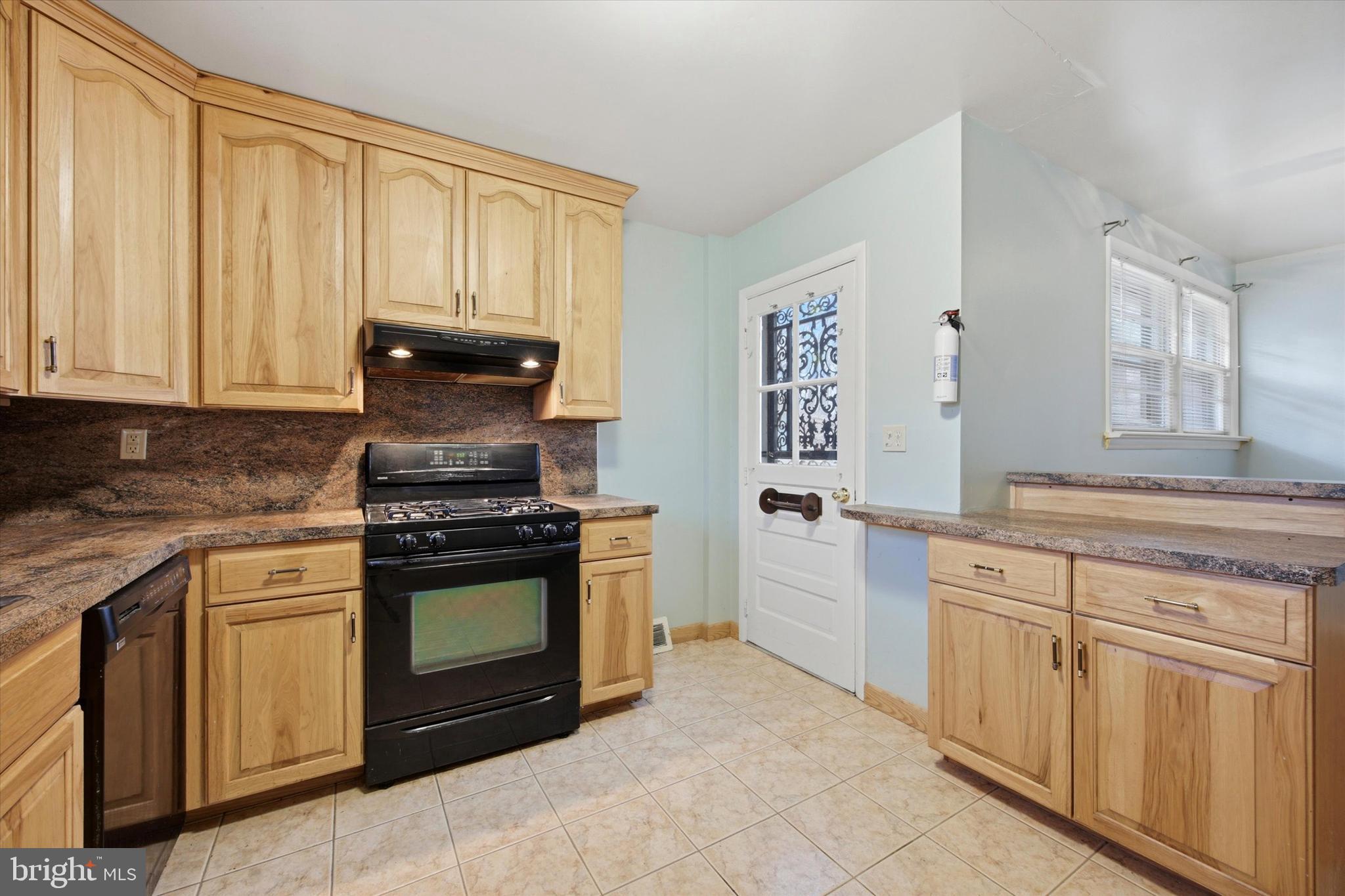 129 Locksley Road Glen Mills, PA 19342 - Photo 10 of 36 a kitchen with stainless steel appliances granite countertop a stove a sink and a microwave